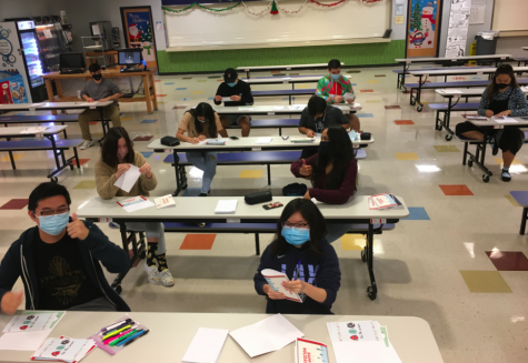 Image of students at The Village School writing holiday cards for local hospitals and nursing homes. 