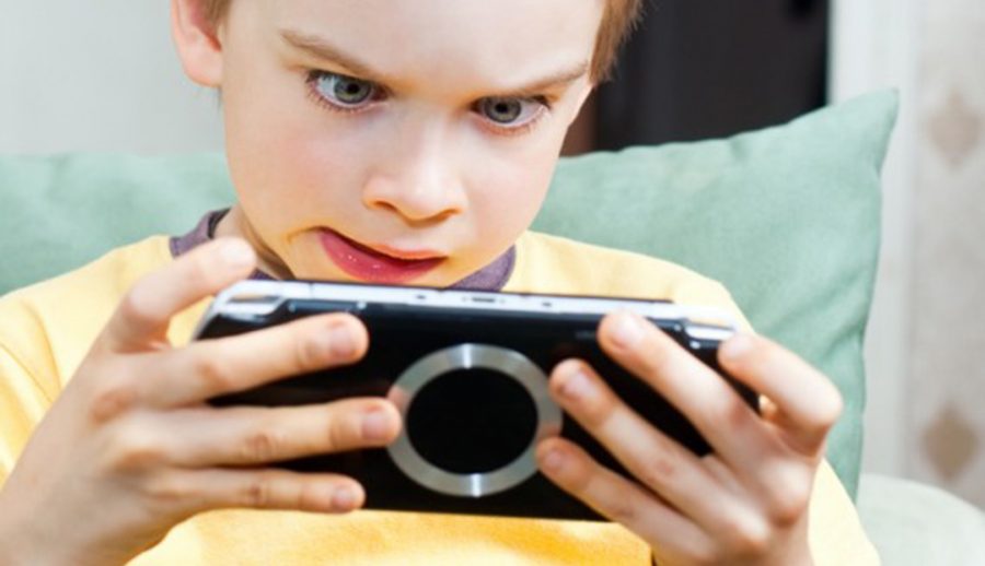 A child mesmerized by his video game(Star Guides Wilderness)