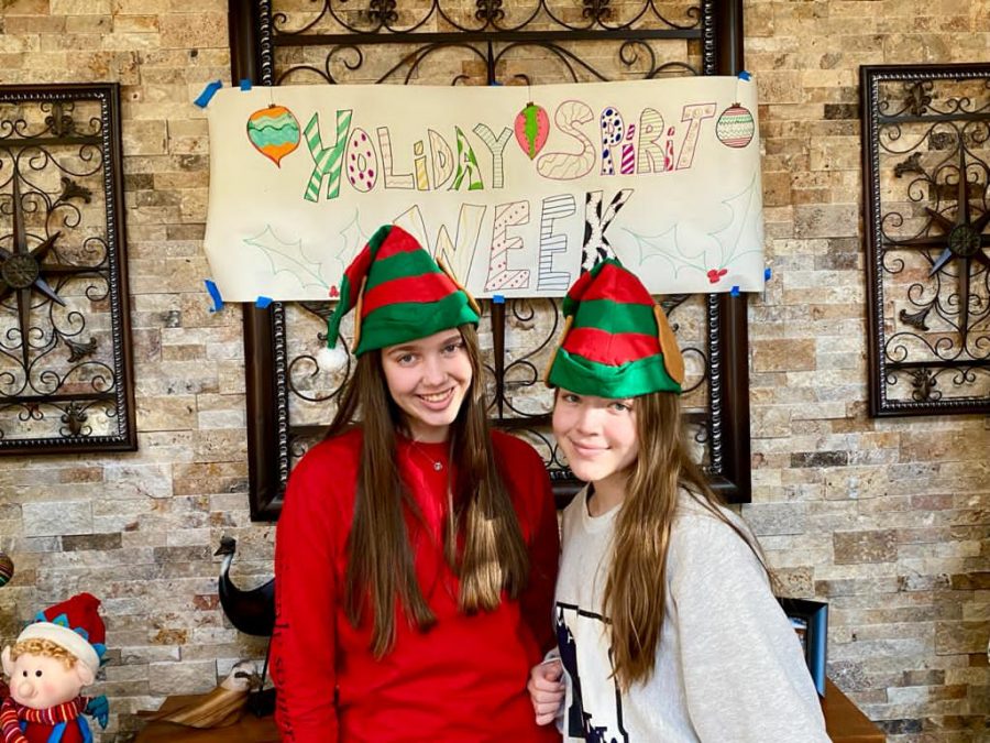 Senior Jillian Mary(12) and her sister Alex Marty(10) posing for a photo in holiday clothes during spirit week 
