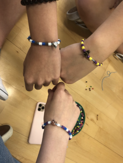 Ava Greer (10),Thanh Giang Tran (10), and Minh Trang Tran (10) exhibiting their completed Tyr bracelets during the 10th and 11th Tyr House meeting. 