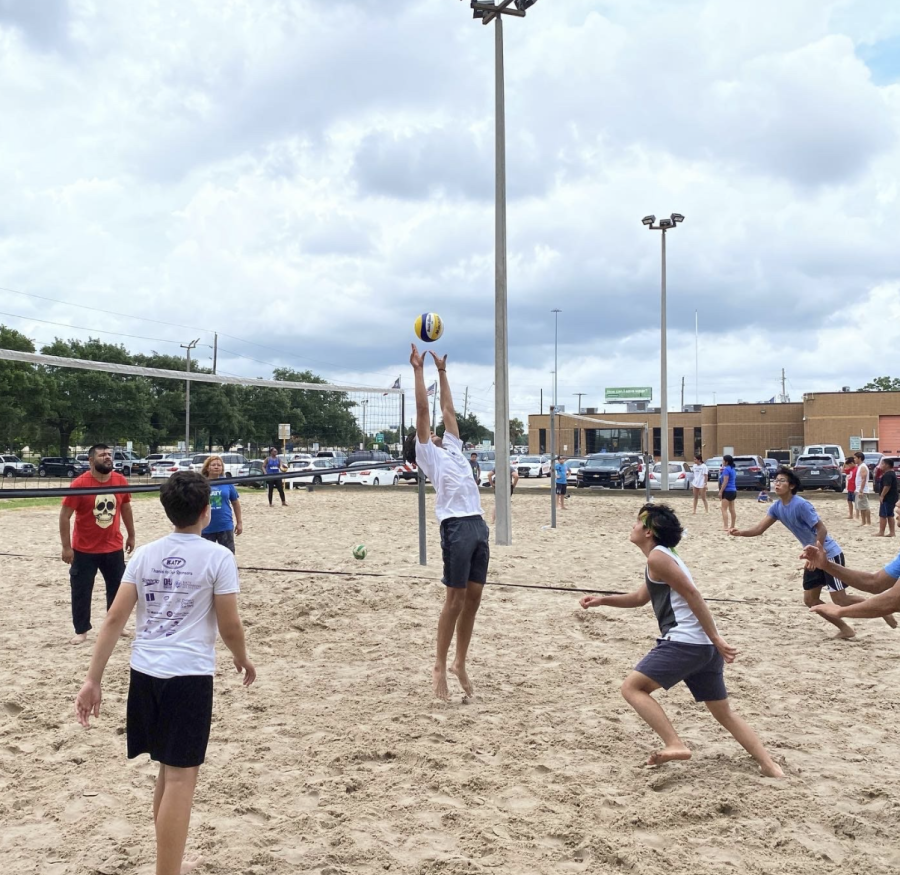 The Village Volleyball club playing sand volleyball.