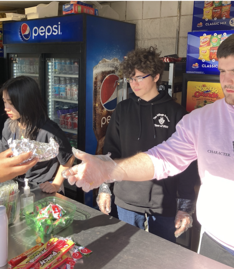 [Left to right] Marshall DeBenedictus (12), Derin Seebord (11), and Sophia Manalo (11) as they run the concession stand.