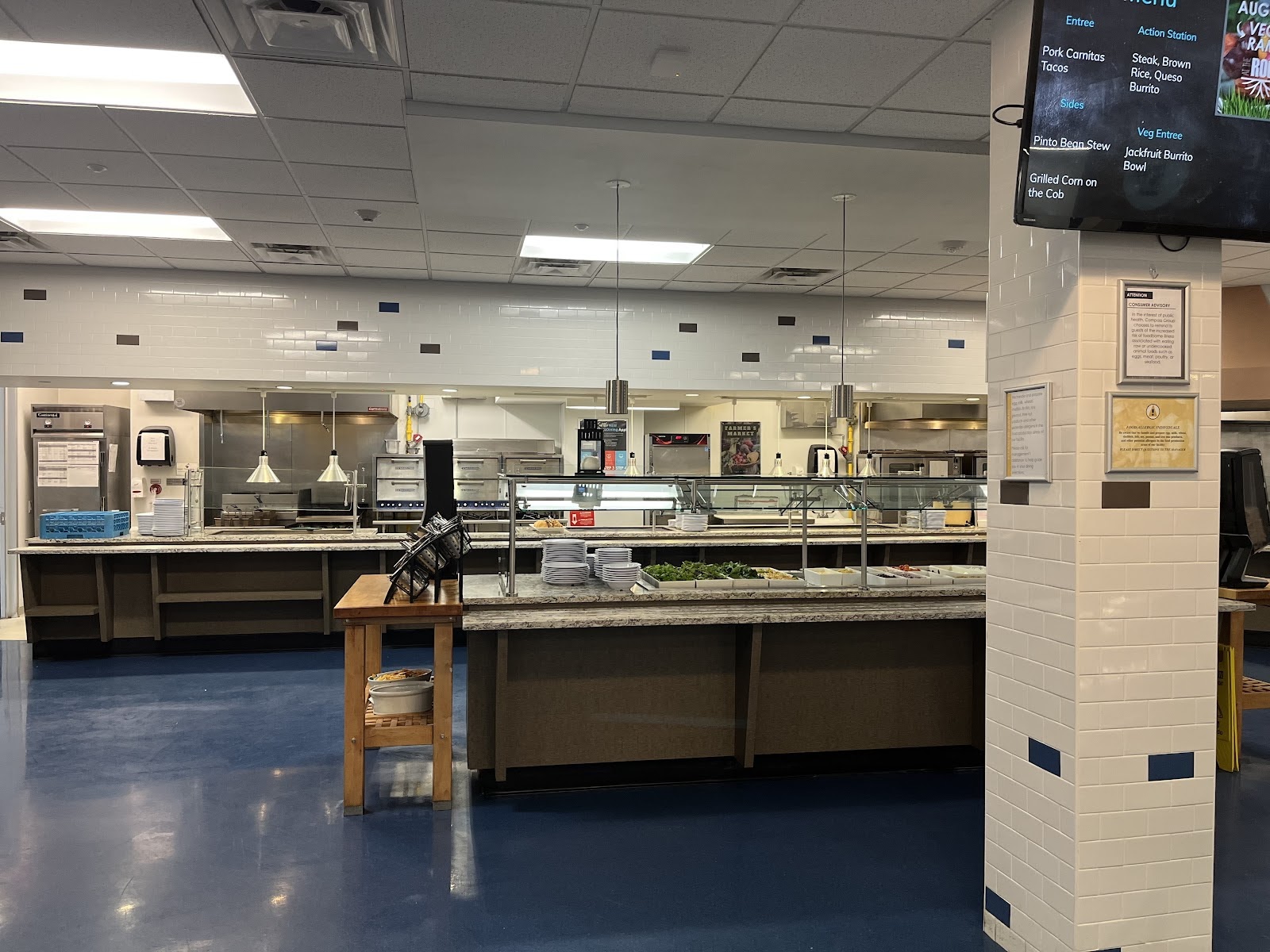 The buffet area of the Village cafeteria where children are served food. Center is salad bar, the back is where the main courses are served including side dishes and deserts. Photo taken by George Masters.