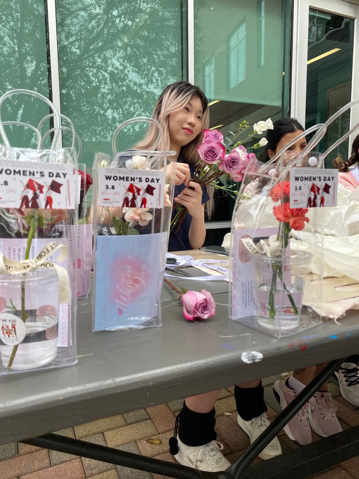 Lily Zhang (11), president of the #MeToo Feminism Club at The Village School hosting a flower sale for Women’s Day. Picture taken by Marlen Gómez. 