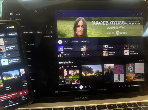 A students Spotify profile displayed on both computer and phone. Photo taken by Kristina Roux