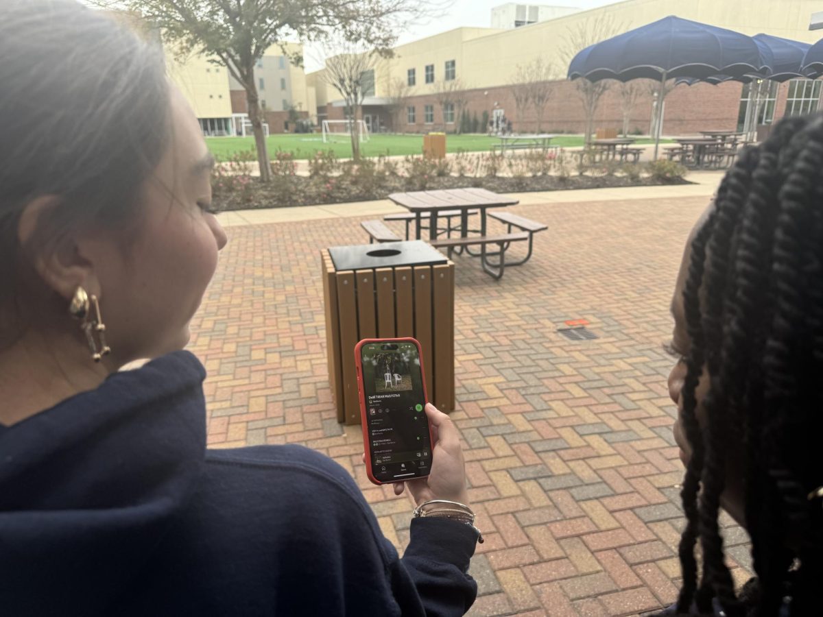 Seniors Camila Rosiles Castolo and Korede Feyisitan listening to  “DeBí TiRAR MáS FOToS” on Spotify.
