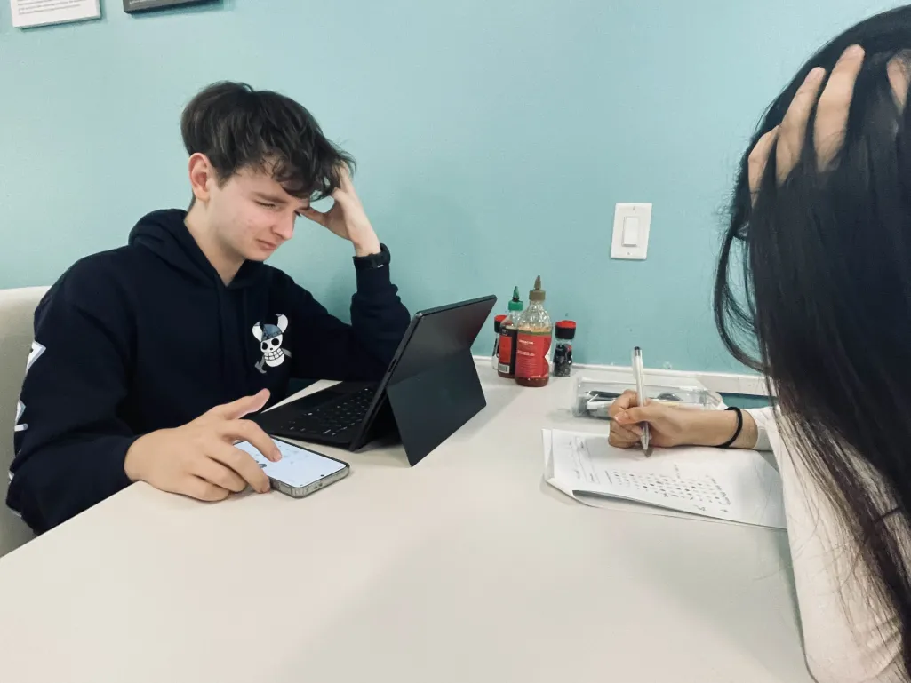Elizar Zinsmeister(10) and Yiran (Annali) Zhao(10) doing digital and paper homework.