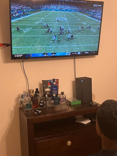 Terrell Braswell playing the Madden 26 video game in his bedroom.
