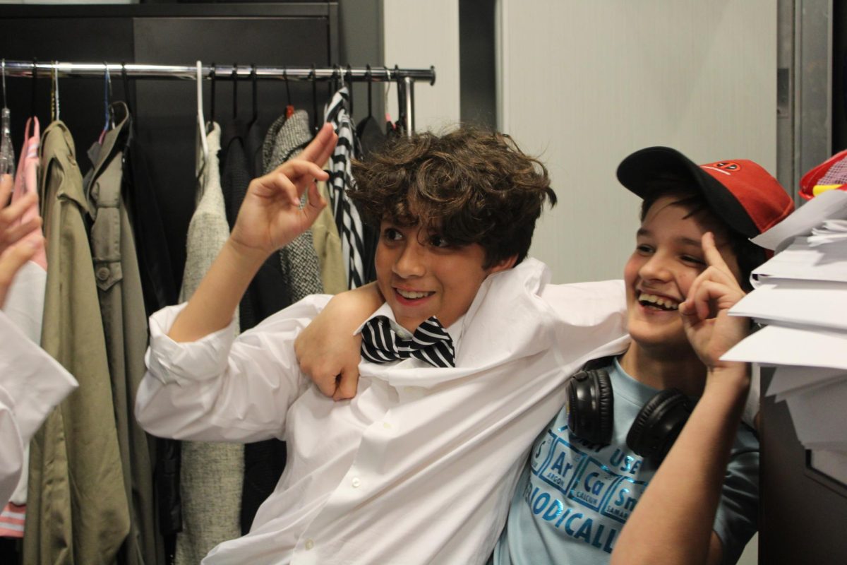 SWITCHOUT: 7th graders Ricardo Garcia and Eagan(Ray) Morrison laugh through an inside joke with castmate Cae Khoo before the Cast A 7:00pm performance in the Village Middle School Theatre's production of Darcy's Cinematic Life on April 30th, 2026, with Garcia and Morrison playing the opposite roles they were in the previous 6:00pm performance.